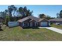 Inviting single-Gathering home boasts a well-kept lawn, fenced yard, and an attached two-car garage at 4490 Sw 169Th Pl, Ocala, FL 34473