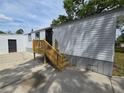 Side view of a one-story home showing the entrance and wooden steps at 5161 Howison Rd, Kissimmee, FL 34746