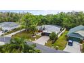Beautiful aerial view of home with mature landscaping, paved driveway, and neighboring houses at 572 Nogales Ct, Kissimmee, FL 34758