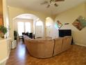 Bright and airy living room with archways, hardwood floors, and neutral paint at 742 Chamberlin Trl, St Cloud, FL 34772