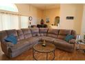 Spacious living room featuring hardwood floors and a comfortable oversized couch at 742 Chamberlin Trl, St Cloud, FL 34772