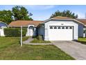 Charming single story home with a well maintained lawn, a garage, and mature landscaping at 907 Robinson Ave, St Cloud, FL 34769