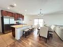 Spacious open concept kitchen with stainless steel appliances, granite counters, and adjacent dining area at 939 Anna Pl, Davenport, FL 33837