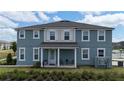 Inviting home exterior showcasing a cozy front porch and tidy landscaping at 11713 Tidal Alley Trl, Orlando, FL 32832
