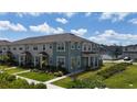 Beautiful townhome exterior featuring manicured landscaping and charming curb appeal at 11713 Tidal Alley Trl, Orlando, FL 32832