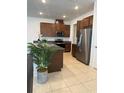 Kitchen showcasing stainless steel appliances and granite countertops at 11713 Tidal Alley Trl, Orlando, FL 32832