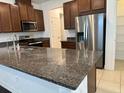 Kitchen island featuring granite countertops and stainless steel appliances at 11713 Tidal Alley Trl, Orlando, FL 32832