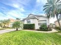 Beautiful home showcasing mature landscaping, a brick driveway, and a well-maintained lawn at 14313 Dulcimer Ct, Orlando, FL 32837
