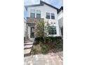 Modern two-story home with stone accents, stylish landscaping, and a paved pathway to the entrance at 236 Villa Domani Cir, Davenport, FL 33896