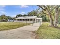 Charming single-story home with a metal roof, fenced yard, a long driveway, and a beautiful lawn at 616 Se 31St Ter, Ocala, FL 34471