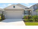 Charming single-story home with a two-car garage, well-manicured lawn, and tasteful landscaping at 6389 Clover St, Lake Hamilton, FL 33851
