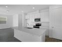 Bright kitchen with white cabinets, stainless steel appliances, and a center island at 6393 Clover St, Lake Hamilton, FL 33851