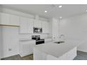 Modern kitchen featuring white cabinetry, stainless steel appliances, and center island at 6393 Clover St, Lake Hamilton, FL 33851