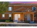 Charming townhome featuring a stucco facade, tiled roof, and well-manicured landscaping, unit #2620 at 2618 Roadster Ln, Kissimmee, FL 34746