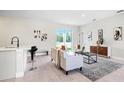 Bright living room with stylish decor, a neutral sofa, and sliding glass doors offering ample natural light at 308 Miami Ln, Kissimmee, FL 34759