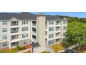 Low rise apartment complex with multiple balconies and a staircase tower offers modern living at 3176 Feltrim Pl # 202, Kissimmee, FL 34747