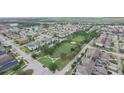 An aerial view of the neighborhood showcasing the community park and surrounding homes at 4710 Nathan Hale Blvd, St Cloud, FL 34769
