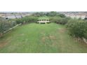 A serene community park featuring mature trees, benches, and a central gathering area at 4710 Nathan Hale Blvd, St Cloud, FL 34769