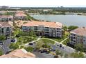 Serene aerial view of a lakeside condo complex showcasing well-manicured grounds and convenient parking at 5012 Shoreway Loop # 205, Orlando, FL 32819