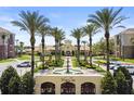 Beautiful Vista Cay Resort entrance featuring lush landscaping, fountain, and palm trees for a welcoming experience at 5012 Shoreway Loop # 205, Orlando, FL 32819