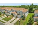 Aerial view of townhomes showing lawns, driveways and common parking areas at 2575 Aventurine St, Kissimmee, FL 34744