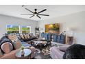 Bright living room with modern furnishings, large windows, ceiling fan, and stylish decor at 109 Pineywoods St, St Cloud, FL 34772