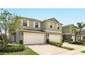 Two-story home featuring a two-car garage, neutral paint, complemented by well-maintained landscaping and bright natural light at 3341 Rodrick Cir, Orlando, FL 32824