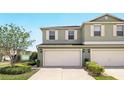 Two-story home featuring a two-car garage, neutral paint, complemented by well-maintained landscaping and bright natural light at 3341 Rodrick Cir, Orlando, FL 32824