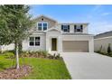 Charming two-story home with neutral colors, a two-car garage, and fresh landscaping at 1743 Carnelian St, Deland, FL 32720