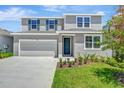 Charming two-story home with a well-maintained lawn, lovely landscaping, and a two car garage at 1745 Carnelian St, Deland, FL 32720