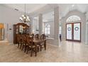 Formal dining room showcasing tile floors, statement chandelier, and sophisticated furniture at 3852 Brantley Place Cir, Apopka, FL 32703