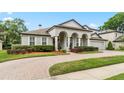 Charming two-story home with manicured landscaping, brick driveway, and a well-maintained lawn at 3852 Brantley Place Cir, Apopka, FL 32703