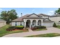 Beautiful two-story home with a brick driveway and well-manicured landscaping and inviting curb appeal at 3852 Brantley Place Cir, Apopka, FL 32703