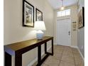 Inviting entryway features tile floors, a console table, and natural light at 8904 Candy Palm Rd, Kissimmee, FL 34747