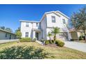 Charming two-story home with a well-maintained lawn, complemented by a two-car garage at 1039 Tourmaline Dr, Kissimmee, FL 34746