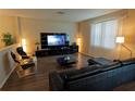 Modern living room showcasing a sleek black entertainment center, comfortable seating, and ample natural light at 1039 Tourmaline Dr, Kissimmee, FL 34746