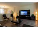Open-concept living room featuring a modern entertainment center, stylish seating, and contemporary decor at 1039 Tourmaline Dr, Kissimmee, FL 34746