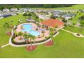 Aerial shot of a community pool and recreation center, surrounded by lush landscaping and walking trails at 1039 Tourmaline Dr, Kissimmee, FL 34746
