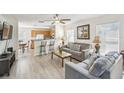 Open-concept living area with a comfortable seating area and views into the adjacent kitchen at 1119 Mariner Cay Dr, Haines City, FL 33844