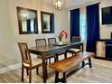 Elegant dining room featuring a modern chandelier, a dining table with seating, and natural lighting at 1122 Spaceport Ct, Kissimmee, FL 34741