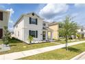 Attractive two-story home boasts a welcoming front porch and beautifully maintained landscaping at 11456 Rhyme Ave, Orlando, FL 32832