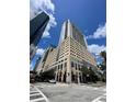 Contemporary high-rise building with a mix of commercial and residential spaces, located at a busy intersection at 155 S Court Ave # 1308, Orlando, FL 32801
