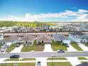 A beautiful aerial view of a community with well-manicured lawns at 16588 Centipede St, Clermont, FL 34714