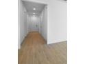 Bright hallway featuring wood-look tile flooring, recessed lighting, and access to multiple rooms at 1747 Carnelian St, Deland, FL 32720