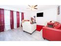 Inviting living room features a ceiling fan and bright, neutral color palette at 2031 Ludlow Ln # 3303, Orlando, FL 32839