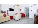 Bright living room boasts a ceiling fan, recessed lights, and modern gray flooring at 2031 Ludlow Ln # 3303, Orlando, FL 32839