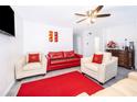 Cozy living area with ceiling fan, recessed lights, gray flooring, and bright color accents at 2031 Ludlow Ln # 3303, Orlando, FL 32839