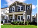 Inviting two-story home boasts a charming front porch with elegant columns and lush green lawn at 2057 Celebration Blvd, Celebration, FL 34747