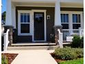 Close up of a charming home entrance, featuring elegant columns and a welcoming front porch at 2057 Celebration Blvd, Celebration, FL 34747