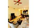Open-concept living area flowing into a dining space with modern tile flooring at 2610 Lodi Cir # 104, Kissimmee, FL 34746